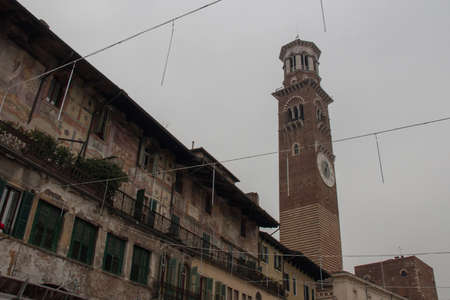 Italy, Verona - December 08 2017: the view of paintings on Mazzanti houses and Torre dei Lamberty at Piazza delle Erbe on December 08 2017, Veneto, Italy.のeditorial素材