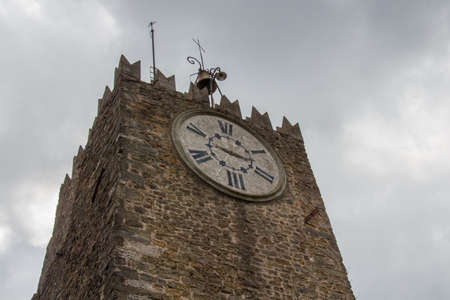 the view of upper fragment of Carmine tower or clock tower, XII century, in Montecatini Alto on...