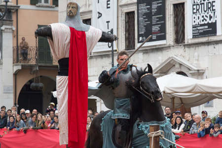 Italy, Brescia - October 01 2017: the view of the knight reaching aim at the traditional knight tournament at celebrations of Caterina Cornaro is coming to the city, medieval festival in Brescia on October 01 2017, Lombardy, Italy.のeditorial素材