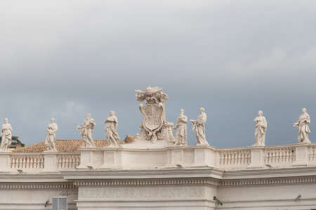 Italy, Vatican city - April 18 2017: the view of group of statues of Peter's Square Colonnade with rainy clouds on background on April 18 2017, Vatican city state, Italy.のeditorial素材