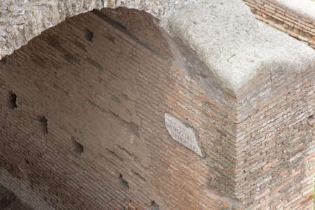 Italy, Ostia - April 16 2017: the view of sign on the wall in The Ancient Roman Port of Ostia Antica on April 16 2017, Lazio, Italy.のeditorial素材