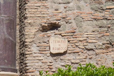 Italy, Rome - April 17 2017: the view of the signpost on athe wall Temple of Romulus, Roman Forum on April 17 2017, Lazio, Italy.のeditorial素材
