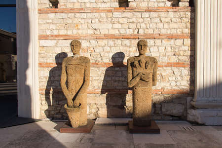 Italy, Brescia - December 24 2017: the view of Tuff Sculptures Testimoni or Witnesses by Italian artist Mimmo Paladino inside the archaeological area of ancient Roman temple ruins of Capitolium in Brescia on December 24 2017, Lombardy, Italy.のeditorial素材
