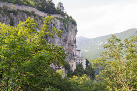 Italy, Ferrara di Monte Baldo - June 03 2018: the view of the church built in mountains, The Sanctuary of Madonna della Corona on June 03 2018, Veneto, Italy.のeditorial素材