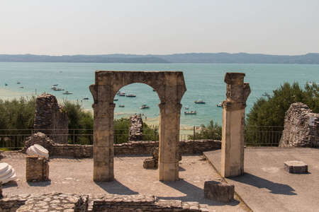 Italy, Lombardy - August 05 2018: the view of roman ruins Grotte di Catullo with Lake garda on background on August 05 2018 in Sirmione, Italy.のeditorial素材