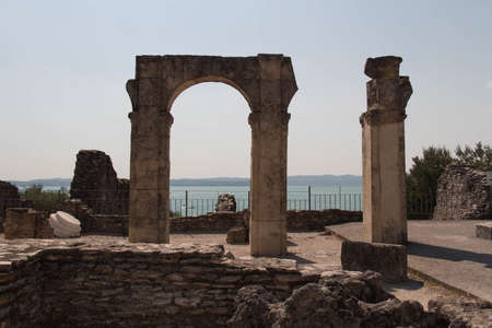 Italy, Lombardy - August 05 2018: the view of roman ruins Grotte di Catullo with Lake garda on background on August 05 2018 in Sirmione, Italy.のeditorial素材