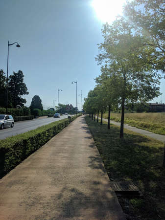 Italy, Lombardy - August 05 2018: the view of sidewalk along road in summer time on August 05 2018...