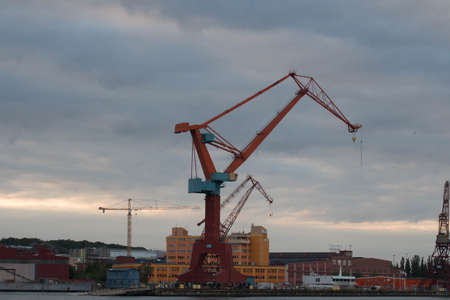 Gothenburg, Sweden - June 17 2019: the view of cranes in Gothenburg harbour at sunset light on June 17 2019 in Gothenburg, Sweden.のeditorial素材