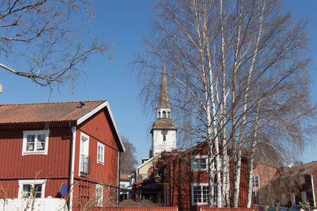 Mariefred, Sweden - April 20 2019: the view of swedish town Mariefred with red houses and white church on background on April 20 2019 in Mariefred, Sweden.のeditorial素材