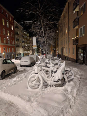 Sweden, Stockholm - February 03 2019: the view of bikes rack in the snow at the roadside on February 03 2019 in Stockholm, Sweden.のeditorial素材