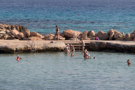 Larnaca, Cyprus - October 16 2019: the view of people bathing in natural lagoon with sea on background on October 16 2019 in Larnaca, Cyprus.のeditorial素材