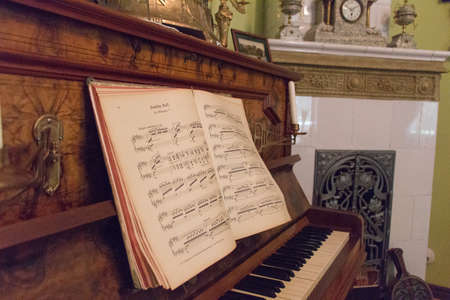 Kaliningrad, Russia - July 31 2019: interior view of Altes Haus Museum, old piano with open sheet music on July 31 2019 in Kaliningrad, Russia.のeditorial素材