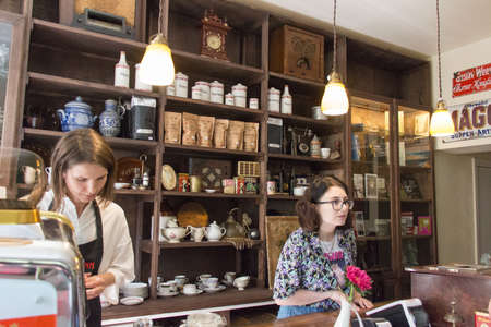 Kaliningrad, Russia - July 31 2019: the view of two saleswomen working behind counter, Gustav Grossmann cafe on July 31 2019 in Kaliningrad, Russia.のeditorial素材