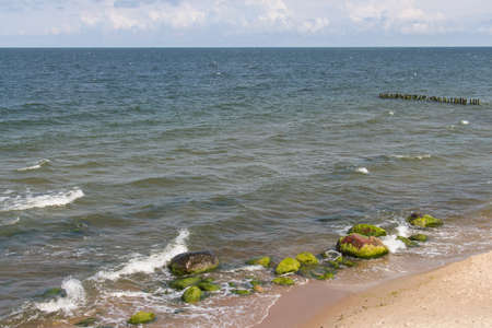 Svetlogorsk, Russia - August 08 2019: the view of stones, breakwaters and sea, marine landscape in summer time on August 08 2019 in Svetlogorsk, Russia.の写真素材