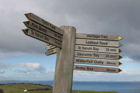 The veiw of wooden track pointer at Shakespear Regional Park, New Zealand.