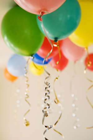 Group of coloured party balloons with gold and silver stringsの写真素材