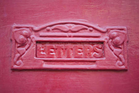 Close Up Of Red Letterbox In Wooden Doorの写真素材