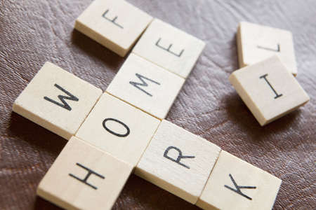 Wooden Tiles In Crossword Shape Spelling Words Home Work And Life To Illustrate Pressures Of Modern Lifeの写真素材