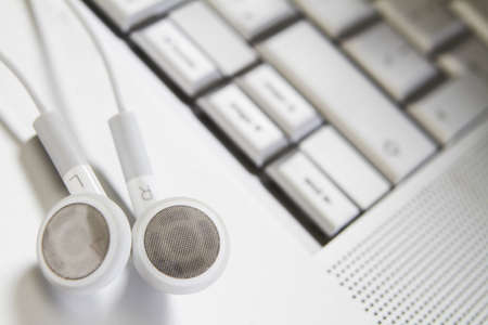 White Earphones On Computer Keyboardの写真素材
