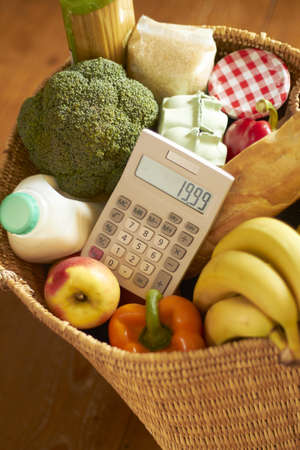 Shopping Basket With Groceries And Calculatorの写真素材