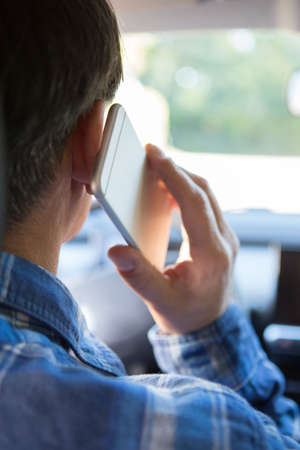Man In Car Talking On Mobile Phone Whilst Drivingの写真素材
