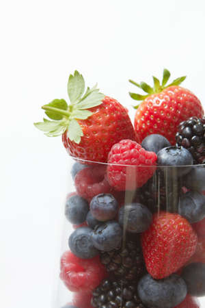Selection Of Summer Fruits In Glass Against White Backgroundの写真素材