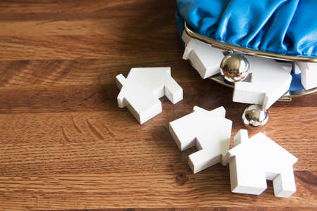 Model Houses With Change Purse To Illustrate House Purchase