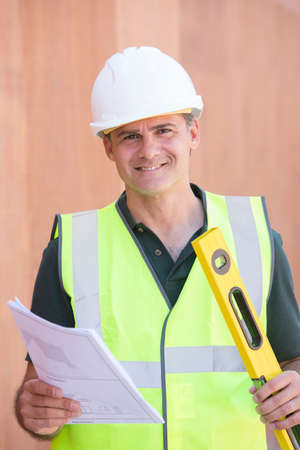 Portrait Of Construction Worker On Building Site With House Plans