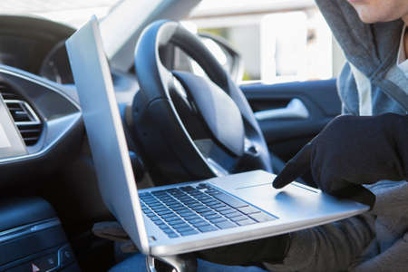Thief Using Laptop To Hack Into Car Security Softwareの写真素材