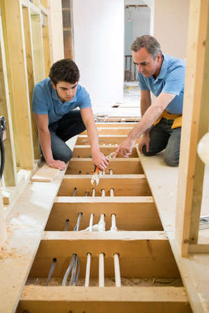 Plumber And Apprentice Fitting Central Heatingの写真素材