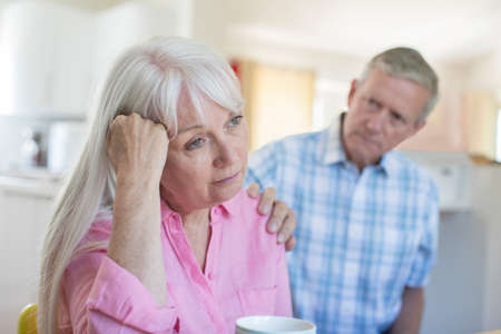 Mature Man Comforting Woman With Depression At Homeの写真素材