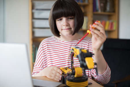 Teenage Girl Building Robotic Arm At Schoolの写真素材