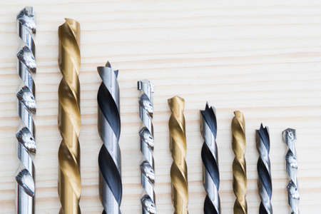 Selection Of Drill Bits Arranged In Descending Size On Wooden Backgroundの写真素材