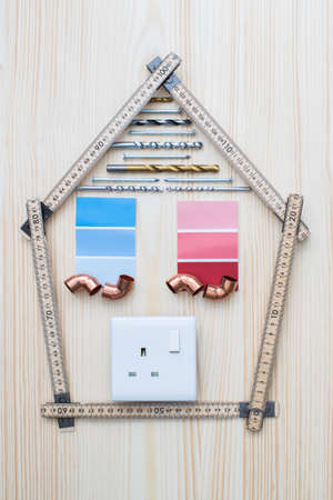 Building Components Arranged In Shape Of House On Wooden Backgroundの写真素材