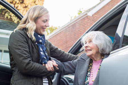 Female Neighbor Giving Senior Woman A Lift In Carの写真素材