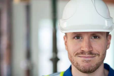 Portrait Of Male Construction Worker On Building Site Wearing Hard Hatの写真素材
