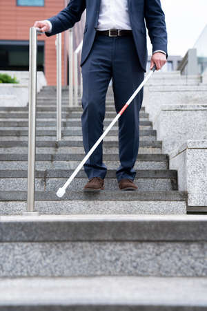 Close Up Of Blind Person Negotiating Steps Outdoors Using Caneの写真素材
