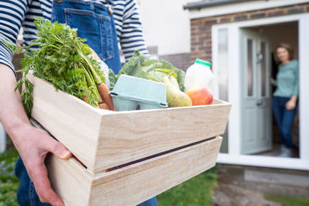 Home Delivery Of Fresh Produce Outside House Observing Safe Social Distancing During Coronavirus Covid-19 Pandemicの写真素材