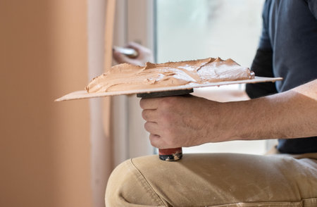 Close Up Of Plasterer Plastering Room Of Houseの写真素材