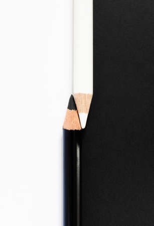 Black And White Pencils Against Contrasting Background To Illustrate Racial Diversity Conceptの写真素材