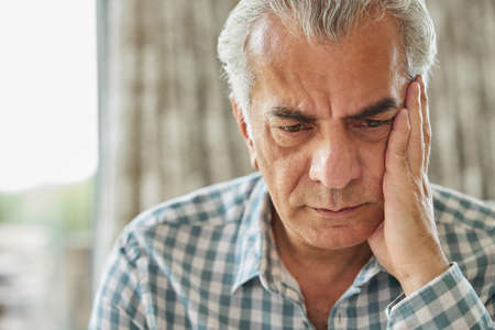 Head And Shoulders Shot Of Worried Senior Man At Homeの写真素材