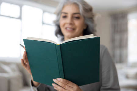 Mature Woman Writing In Journal Or Diary At Homeの写真素材