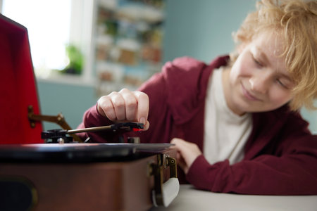 Teenage Girl Playing Vinyl Records On Record Player At Home In Bedroomの写真素材