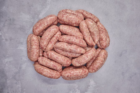 Overhead shot of pile of sausages on background in butchers shopの写真素材