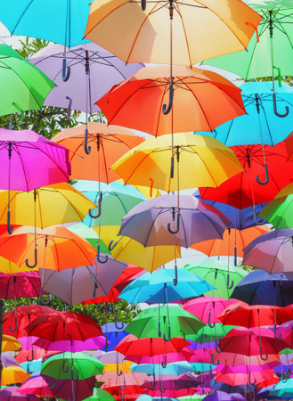 Vibrant Hanging Umbrellas Display. Lots of umbrellas coloring the sky.の写真素材
