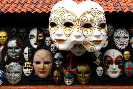 A diverse and ornate collection of decorative masks on display. The traditional beautiful Venetian mask.の写真素材