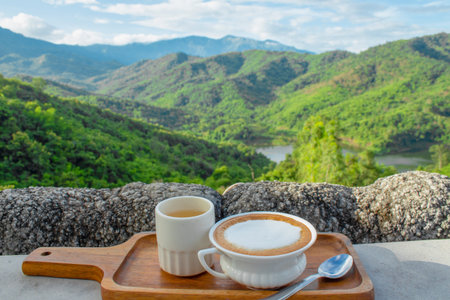Coffee and Tea with a Breathtaking Mountain View.Coffee latte art with hot tea. The front view ,の写真素材