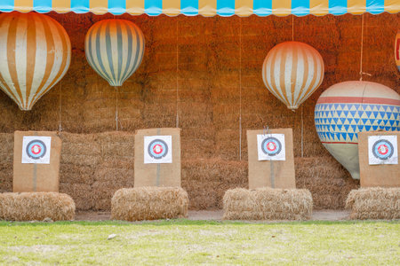 Outdoor Carnival Game Booth with Archery Targets and Hot Air Balloon Decor.