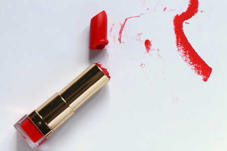 Broken Red Lipstick and Smudges on White.の写真素材