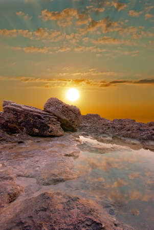 Natural sunset at the seaside  Surface water and rocksの写真素材